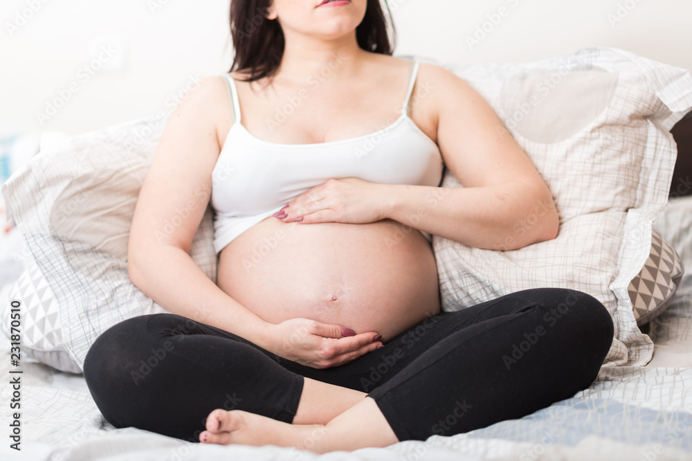 Pregnant woman with hands on her belly Pregnant woman with hands on her belly