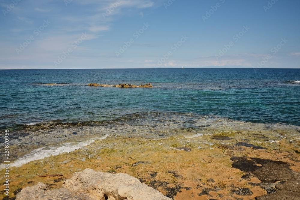 typical red and orange seascape in Mediterranean sea cliffs clear water seascape rocks on the shore