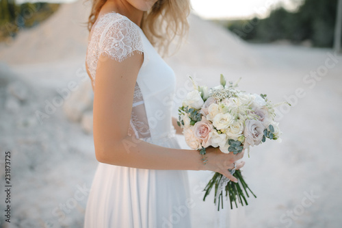 Bride with a beautiful wedding bouquet in light colors