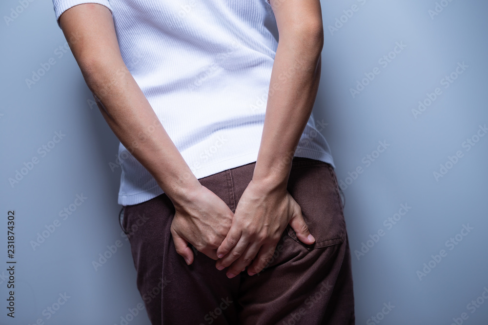 Woman holding her bottom Woman holding her bottom