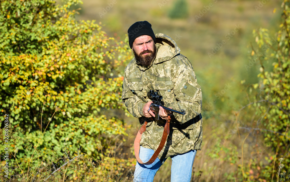 Harvest animals typically restricted. Guy hunting nature environment. Bearded hunter rifle nature background. Hunting hobby concept. Hunting season. Experience and practice lends success hunting