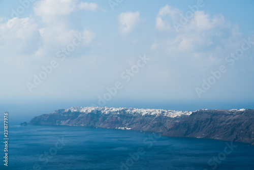 view of Oia town in the distance across the sea, Santorini