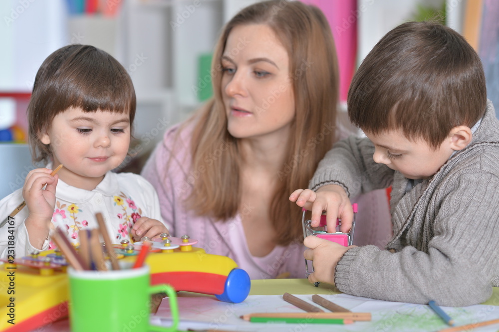 Portrait of a mother with children playing together Portrait of a mother with children playing together