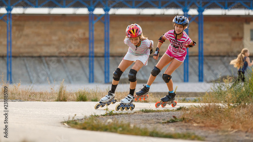 Two girls training in speed skating on rollerdrome