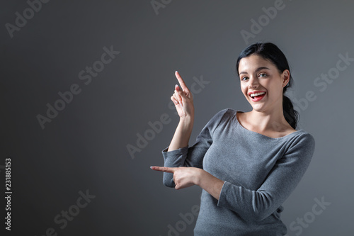 Young woman with a displaying hand gesture