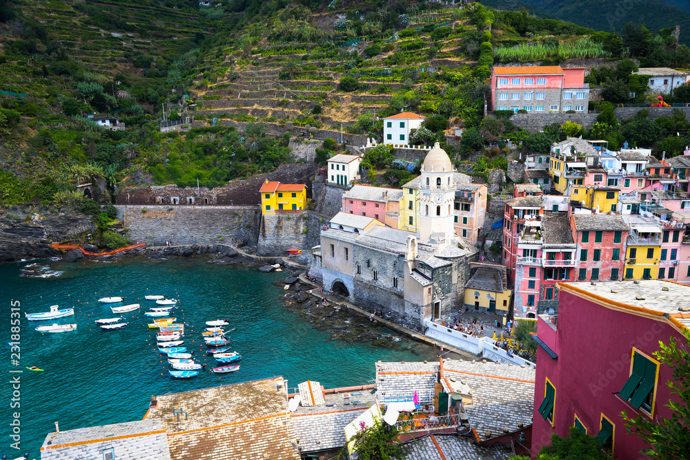 Beautiful wharf in old Italian village Vernazza (Chinque Terre) with bright colorful houses and boats.
