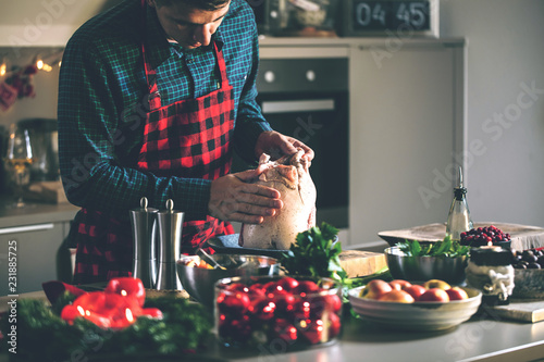 Man preparing delicious and healthy food in the home kitchen for christmas (Christmas Duck or Goose)