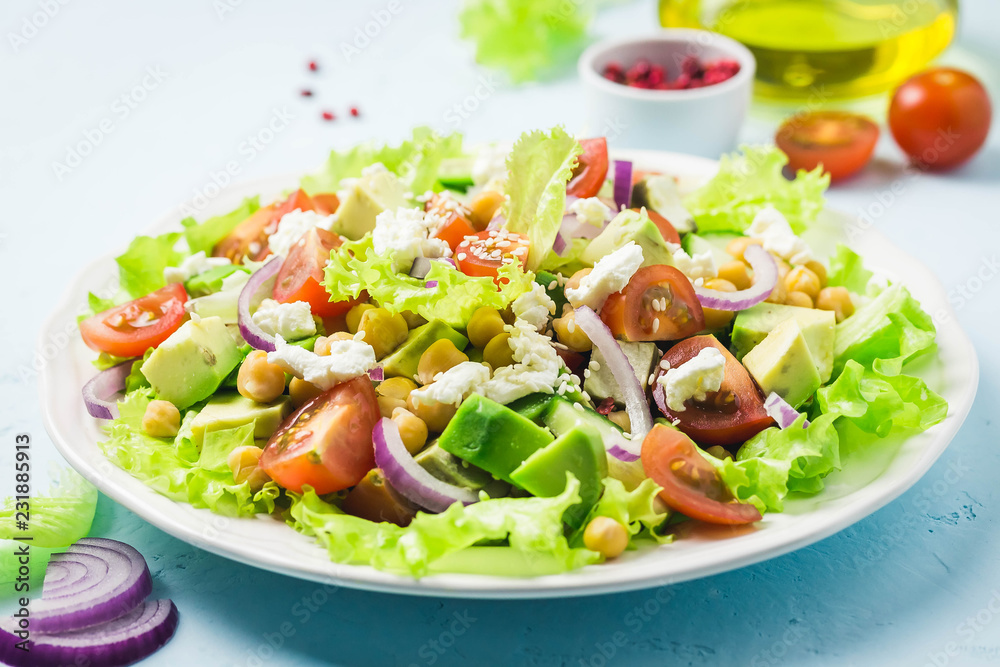 Garbanzo beans avocado cherry tomato feta cheese salad with lemon dressing. Selective focus, space for text. Garbanzo beans avocado cherry tomato feta cheese salad with lemon dressing. Selective focus, space for text.
