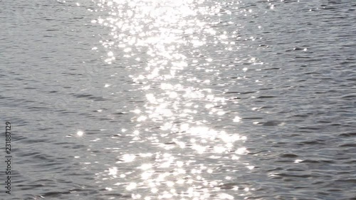 A strip of sunlight on a moving wavy water surface