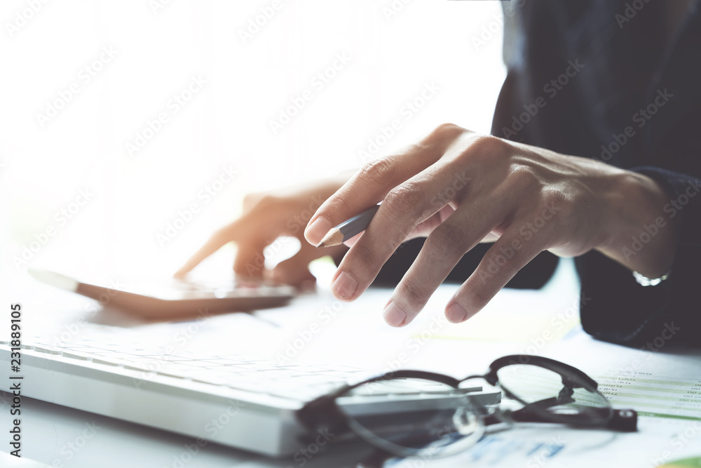 Business accounting, Business man using calculator with computer, budget and loan paper in office. Business accounting, Business man using calculator with computer, budget and loan paper in office.