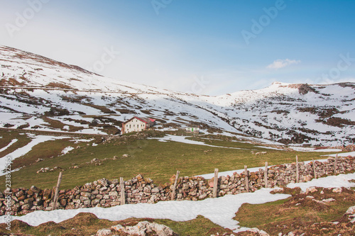Beautiful remote house on slope of snowy mountains photo