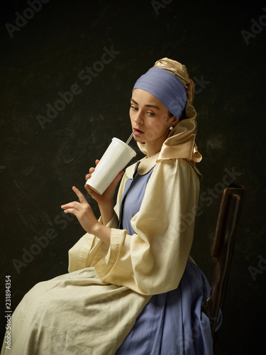 Medieval Woman in Historical Costume Wearing Corset Dress and Bonnet. Beautiful peasant girl wearing thrush costume with Coca Cola