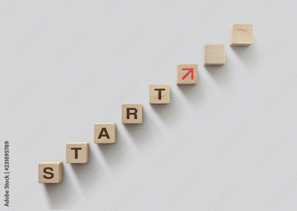 Wooden blocks arranged in stair shape with the word START. Start, Start up, new career or new business, start to success or mindset concept. Wooden blocks arranged in stair shape with the word START. Start, Start up, new career or new business, start to success or mindset concept.