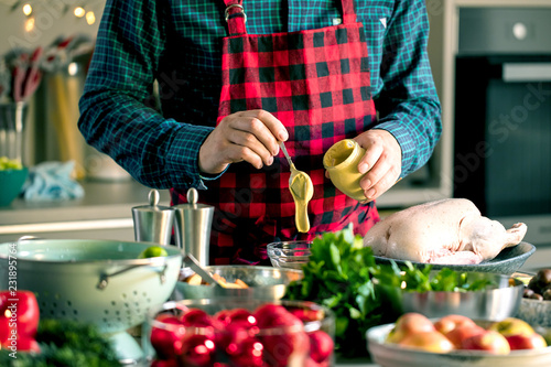 Man preparing delicious and healthy food in the home kitchen for christmas (Christmas Duck or Goose)