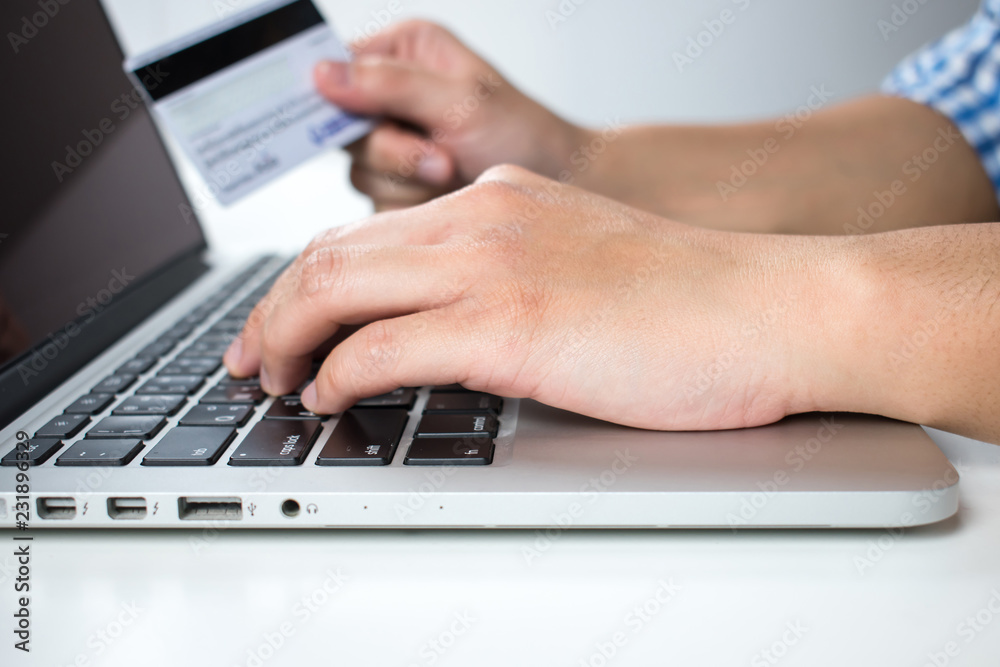 The hands of a blue plaid shirt are paying by credit card. The hands of a blue plaid shirt are paying by credit card.