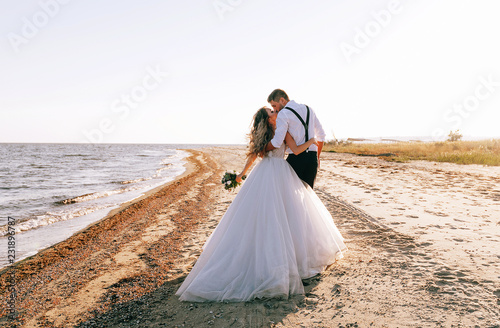 Obraz na płótnie bride and groom on the seashore. wedding concept on the sea, on a fabulous island. w salonie