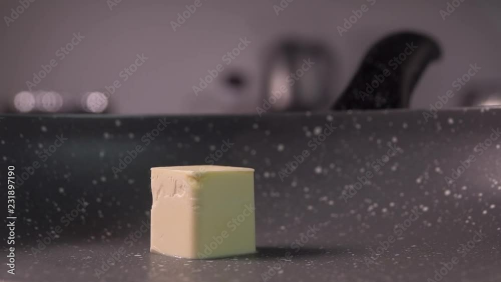 cube of butter fall on frying pan, slow motion, 240 fps cube of butter fall on frying pan, slow motion, 240 fps