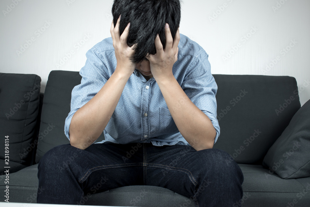 People are stressed, disappointed and sad sitting on a sofa in the room. People are stressed, disappointed and sad sitting on a sofa in the room.