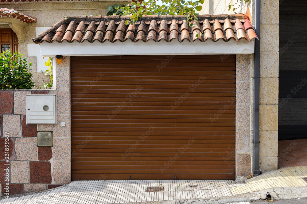 Naklejka premium metal garage door in a stone wall