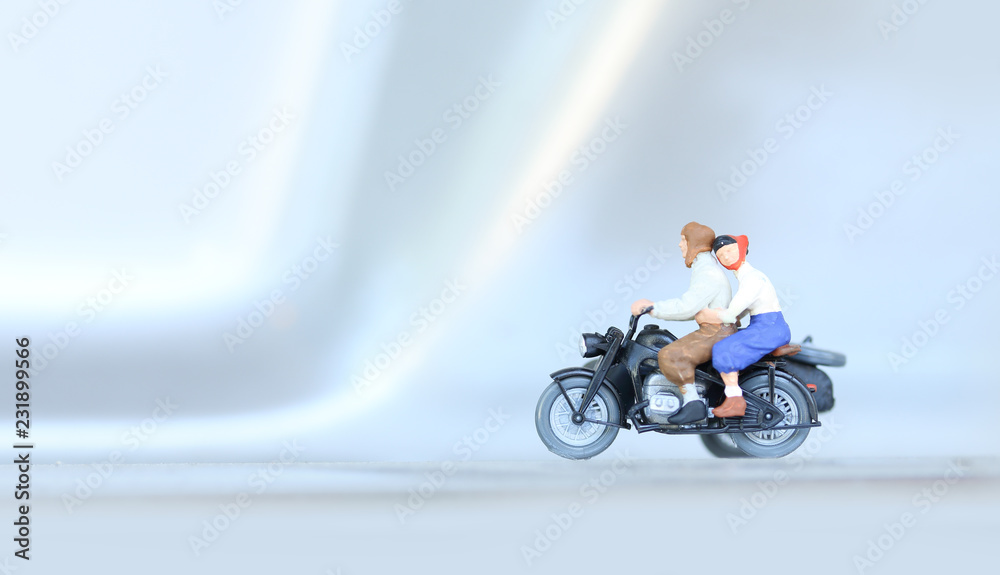 Fototapeta premium Miniature people bride and groom couple with motorcycle