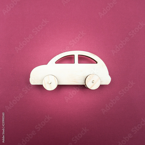 Stylish wooden car on a monophonic background. Minimalism, View from above, flat lay photo