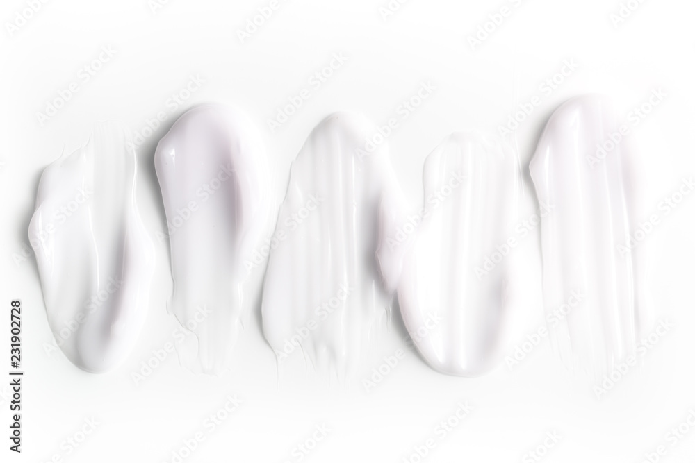 A group of textured strokes of moisturizers on a white background. A group of textured strokes of moisturizers on a white background.