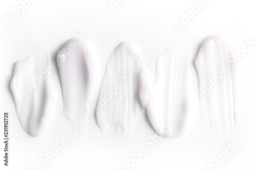 A group of textured strokes of moisturizers on a white background.