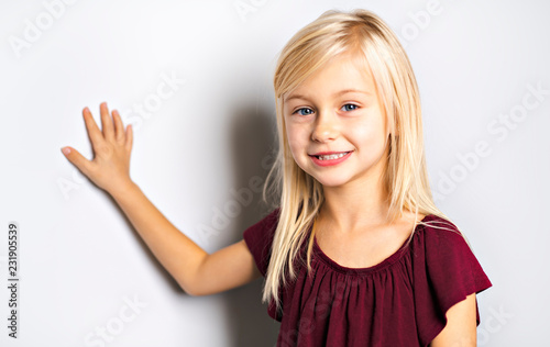 A Cute girl 5 year old posing in studio