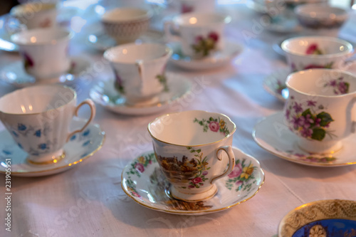 Tea cups on a table with white tablecloth