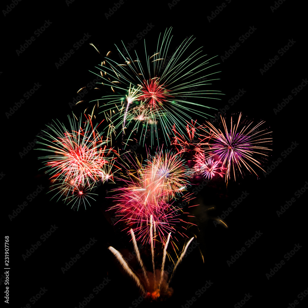 Colourful Fireworks at night isolated over dark black sky