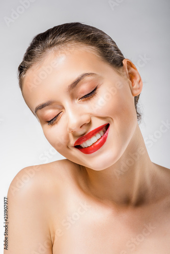 young smiling beautiful woman with red lips and closed eyes