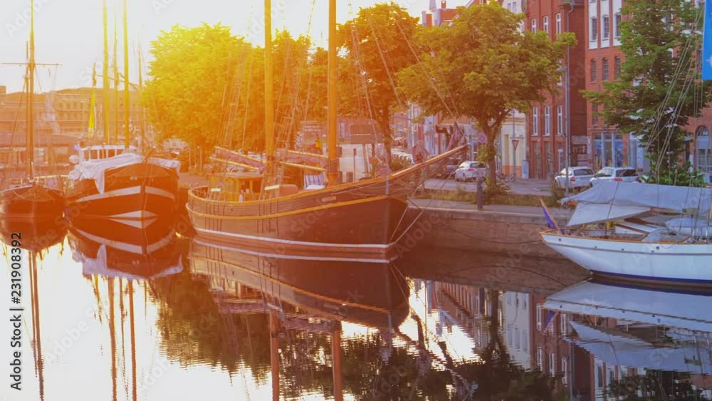 Boats or vessels on the Trave river. Embankment in Lubeck city. 