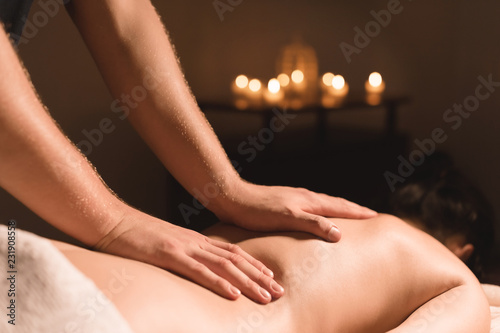 Close-up of male hands. Masseur does massage for the waist of a young girl. Rehabilitation  beauty therapy medicine. healthy concept