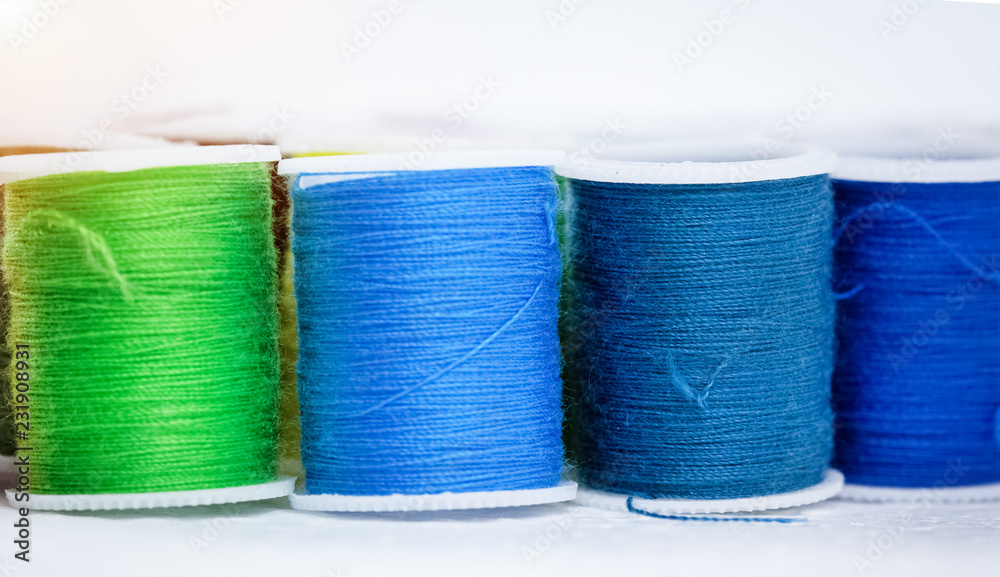 The roll of colorful thread on background,show texture of thread,forneedlework,craft,sewing and tailoring concept The roll of colorful thread on background,show texture of thread,forneedlework,craft,sewing and tailoring concept