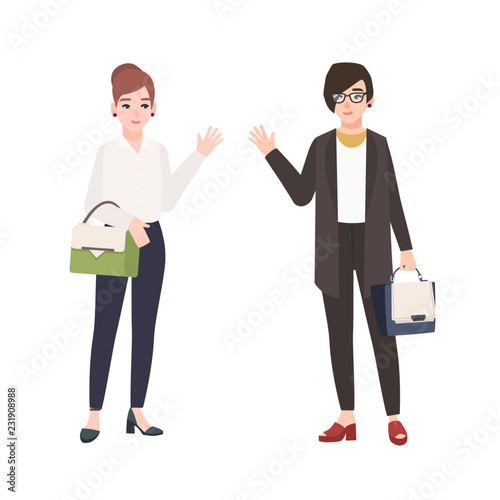 Pair of smiling women dressed in business clothes or female office workers greet each other