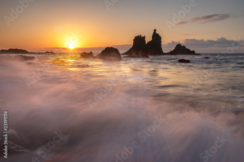 beautiful Benijo beach in Tenerife, waves crashing against boulders during sunset © Mike Mareen