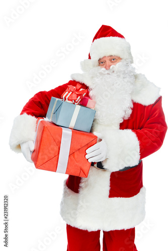 smiling santa claus with christmas presents isolated on white © LIGHTFIELD STUDIOS