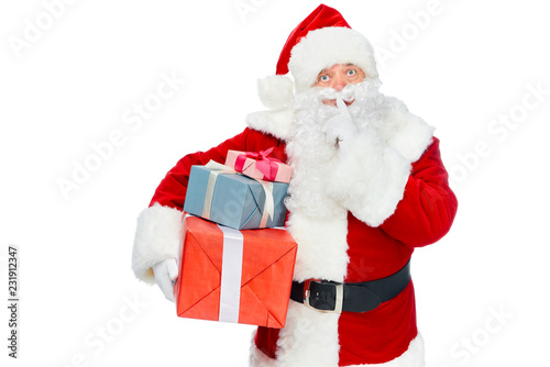 santa claus with christmas presents showing silence symbol isolated on white