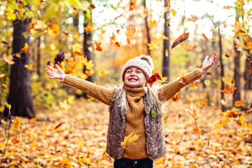 An Autumn portrait of cute blond child girl