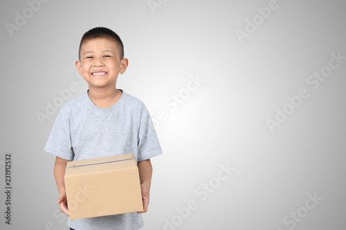 Asian kid holding empty cardboard box isolated on white background