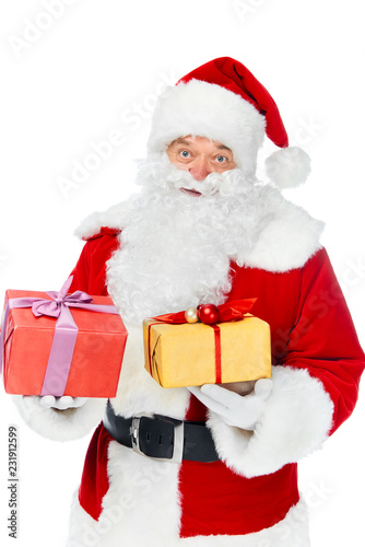 santa claus in hat with christmas gift boxes isolated on white © LIGHTFIELD STUDIOS