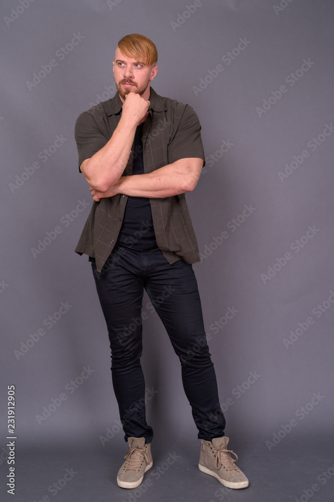 Bearded man with blond hair against gray background Bearded man with blond hair against gray background