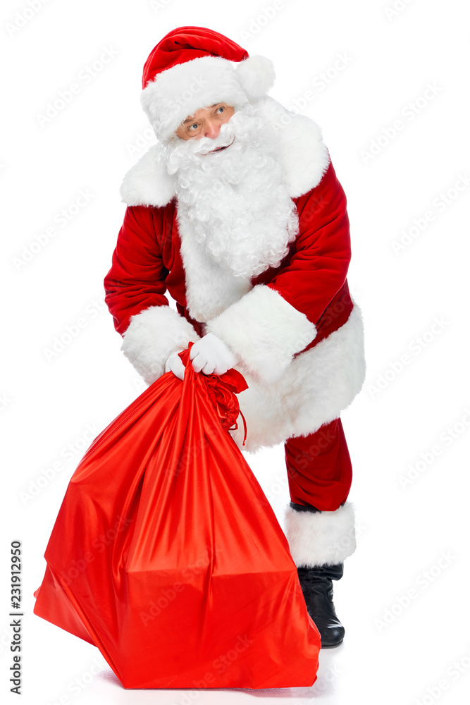santa claus holding red christmas bag isolated on white santa claus holding red christmas bag isolated on white