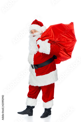 santa claus carrying red christmas bag isolated on white
