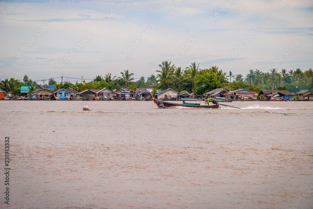 Fishing boats and houses over the Krabi river Fishing boats and houses over the Krabi river
