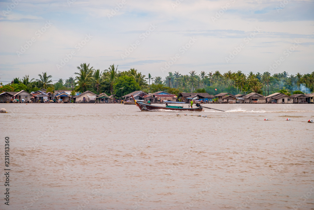 Fishing boats and houses over the Krabi river Fishing boats and houses over the Krabi river