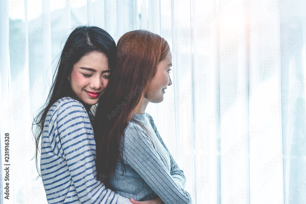 Two Asian Lesbian women hug and embracing together in bedroom. Couple people and Beauty concept. Happy lifestyles and home sweet home theme. Homosexual life theme. Love scene making of female Two Asian Lesbian women hug and embracing together in bedroom. Couple people and Beauty concept. Happy lifestyles and home sweet home theme. Homosexual life theme. Love scene making of female