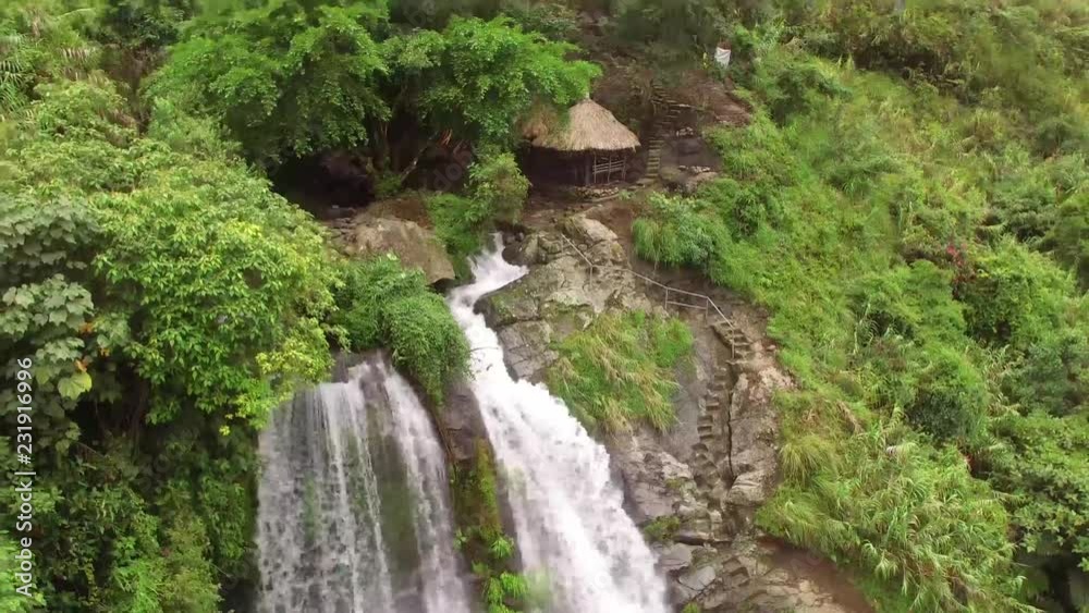 Mayaoyao, Ifugao, Philippines - August 27, 2018: Rocky mountain multi layer waterfalls replete with natural grown trees. drone aerial Mayaoyao, Ifugao, Philippines - August 27, 2018: Rocky mountain multi layer waterfalls replete with natural grown trees. drone aerial