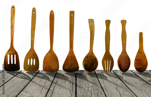 Old wooden kitchen utensils on rustic wooden table isolated on white background. Clipping path Included.