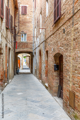 Empty alley with old brick houses